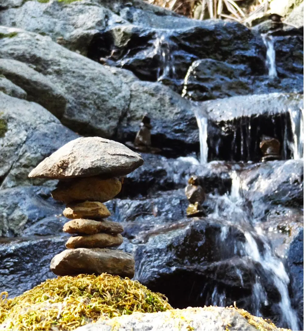 Ephemeral art assembled from natural materials beside a creek